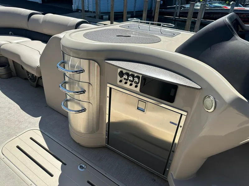 Slide: The Image of 2018 Avalon Catalina Platinum Entertainer boat interior with seating and control panel. - 13