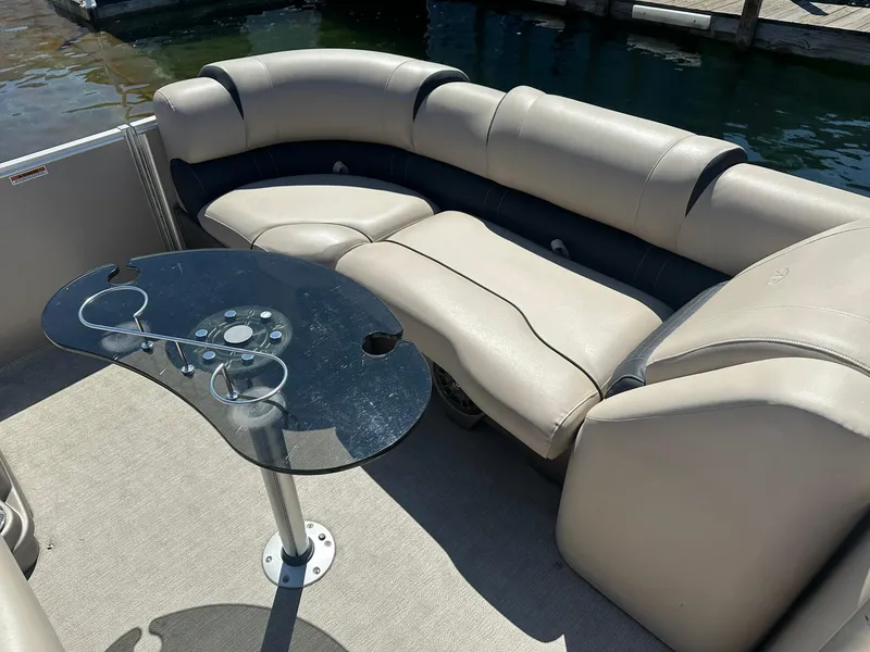 Slide: The Image of 2018 Avalon Catalina Platinum Entertainer boat interior with plush seating and glass table. - 18