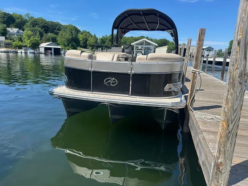 Slide: The Image of 2018 Avalon Catalina Platinum Entertainer pontoon boat docked on a sunny day. - 2