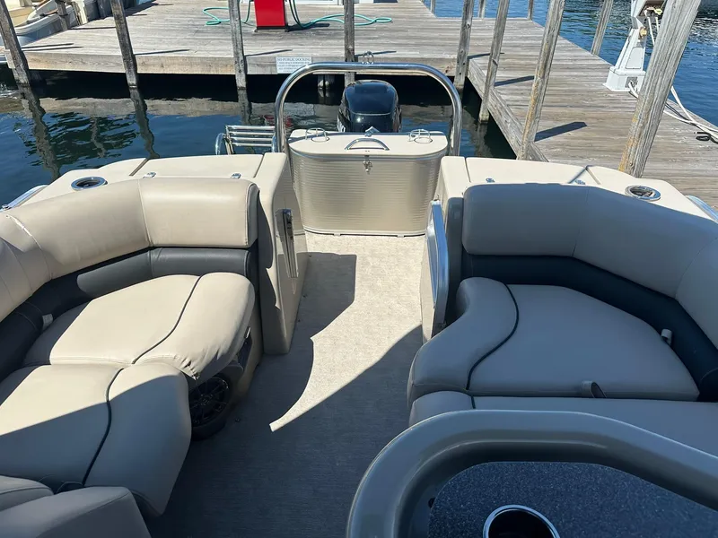Slide: The Image of 2018 Avalon Catalina Platinum Entertainer boat interior with plush seating at a dock. - 21
