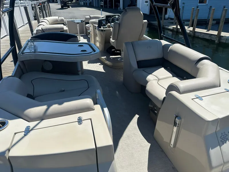 Slide: The Image of 2018 Avalon Catalina Platinum Entertainer boat interior with luxurious seating and table setup. - 7