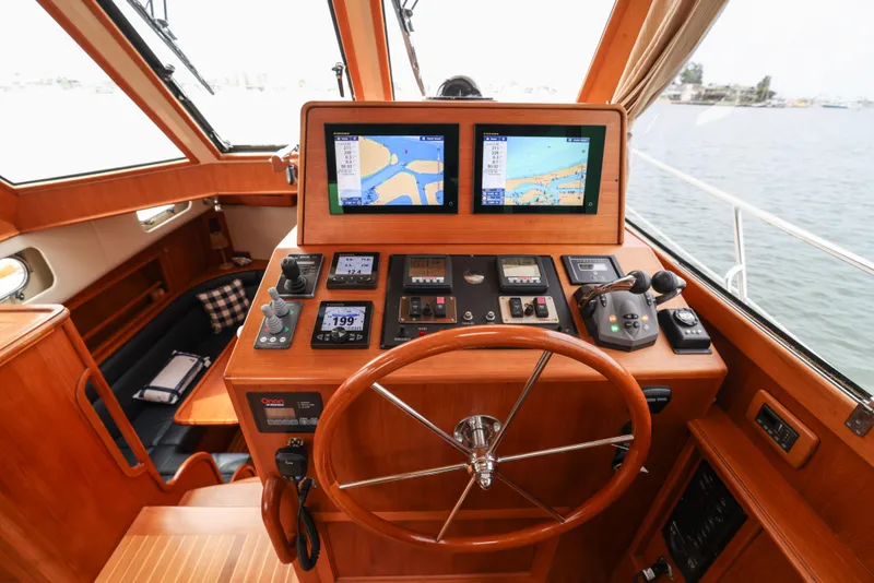 Slide: The Image of Helm of 2008 Grand Banks EASTBAY 39 SX with navigation screens and controls. - 11