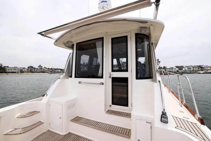 Slide: The Image of 2008 Grand Banks EASTBAY 39 SX yacht with sleek deck and waterfront view. - 2