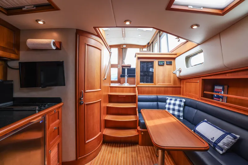 Slide: The Image of Luxurious interior of 2008 Grand Banks EASTBAY 39 SX yacht with wood finish and seating area. - 21
