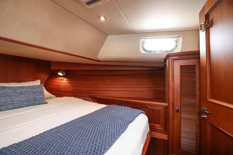 Slide: The Image of Luxurious 2008 Grand Banks EASTBAY 39 SX cabin with wood paneling and cozy bedding. - 29