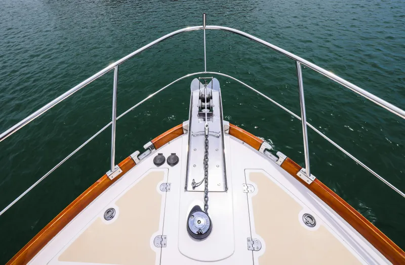 Slide: The Image of Bow of 2008 Grand Banks EASTBAY 39 SX yacht with anchor chain over water. - 5