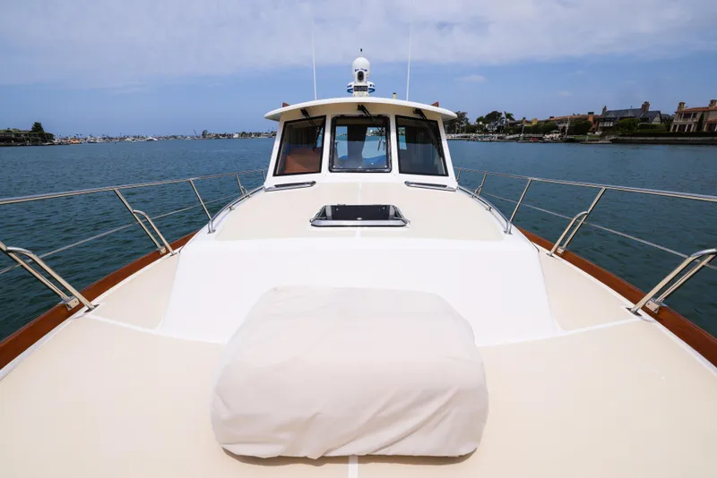 Slide: The Image of 2008 Grand Banks EASTBAY 39 SX yacht on calm waters, showcasing sleek deck design. - 6