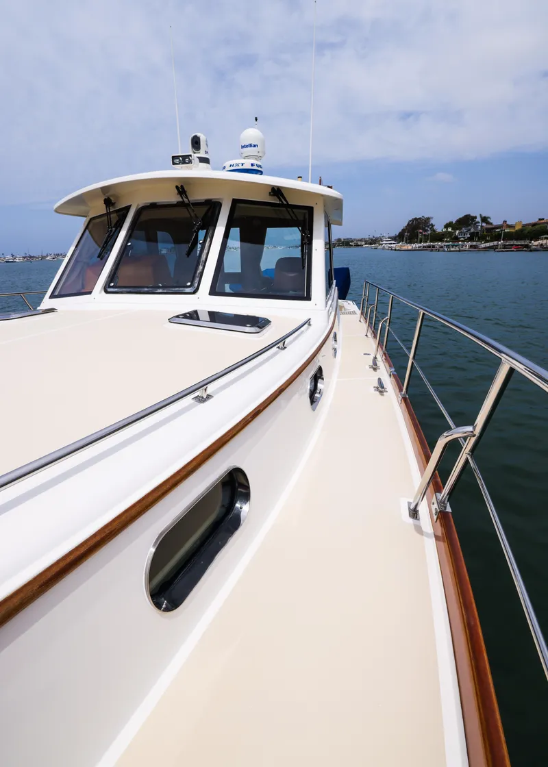 Slide: The Image of 2008 Grand Banks EASTBAY 39 SX yacht on calm water, showcasing sleek design and craftsmanship. - 7