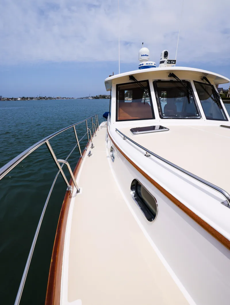 Slide: The Image of 2008 Grand Banks EASTBAY 39 SX yacht on calm water, showcasing sleek design and craftsmanship. - 8