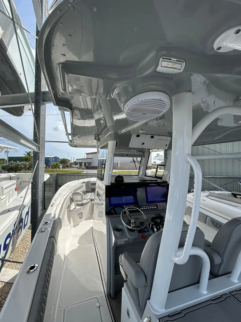Slide: The Image of 2024 Sea Pro 320 DLX Center Console boat interior with modern helm and seating. - 11