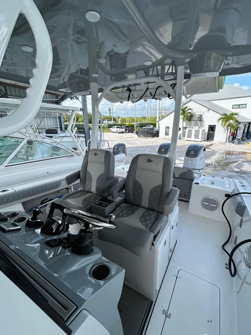Slide: The Image of 2024 Sea Pro 320 DLX Center Console boat interior with modern seating and controls. - 13