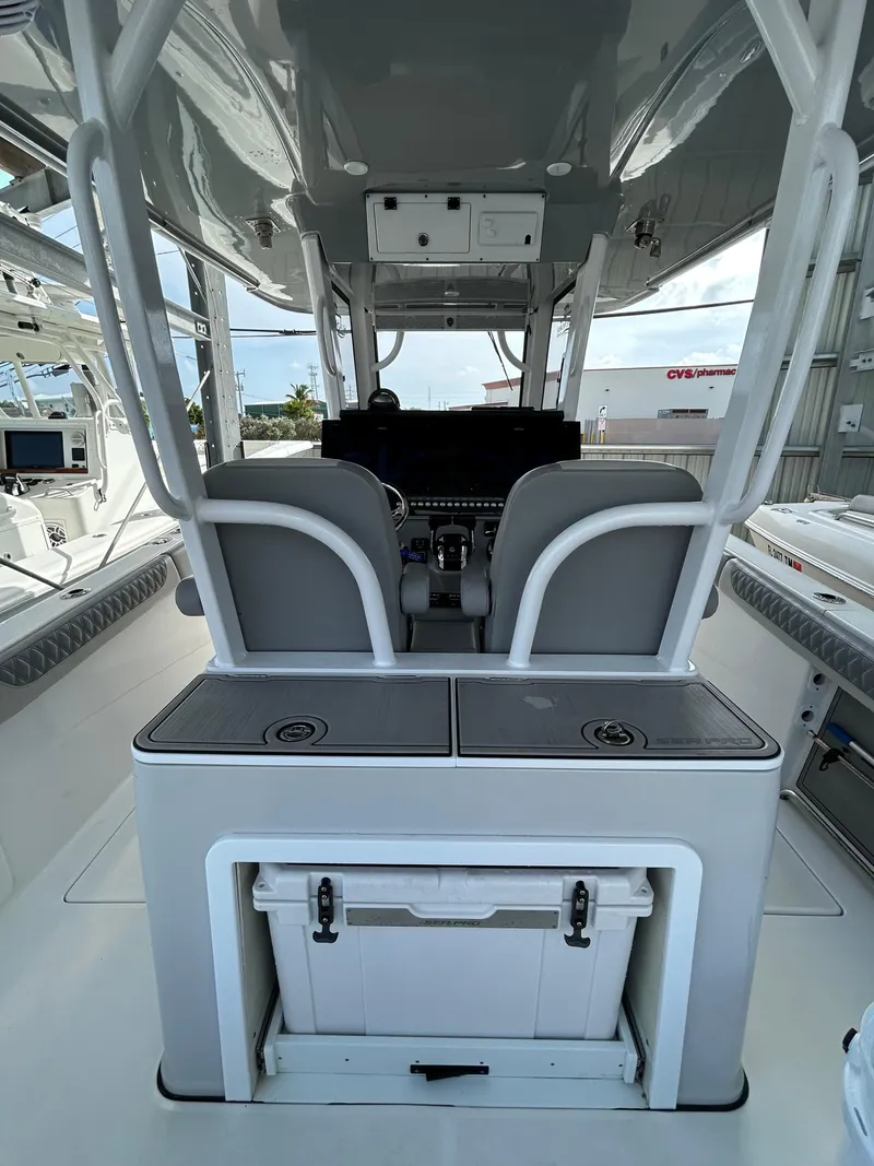 Slide: The Image of 2024 Sea Pro 320 DLX Center Console interior with helm and seating area. - 15