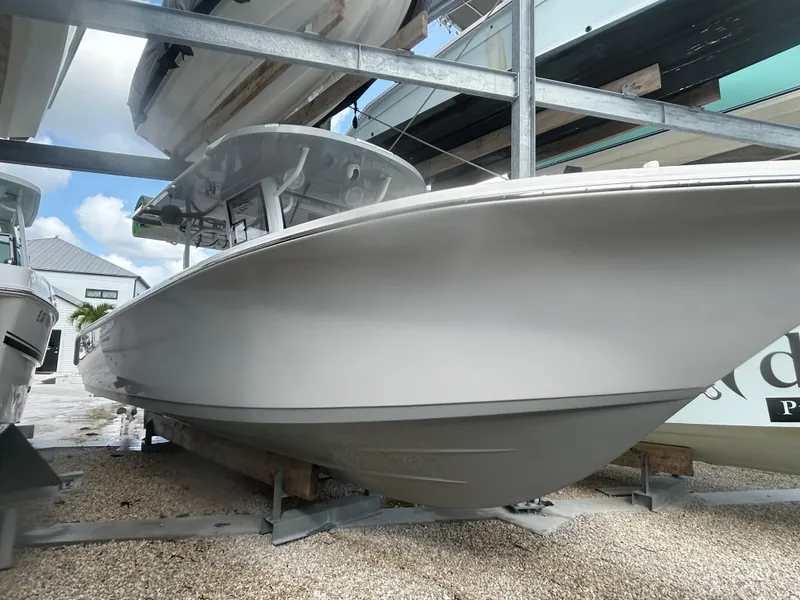 Slide: The Image of 2024 Sea Pro 320 DLX Center Console boat on display in a marina. - 4
