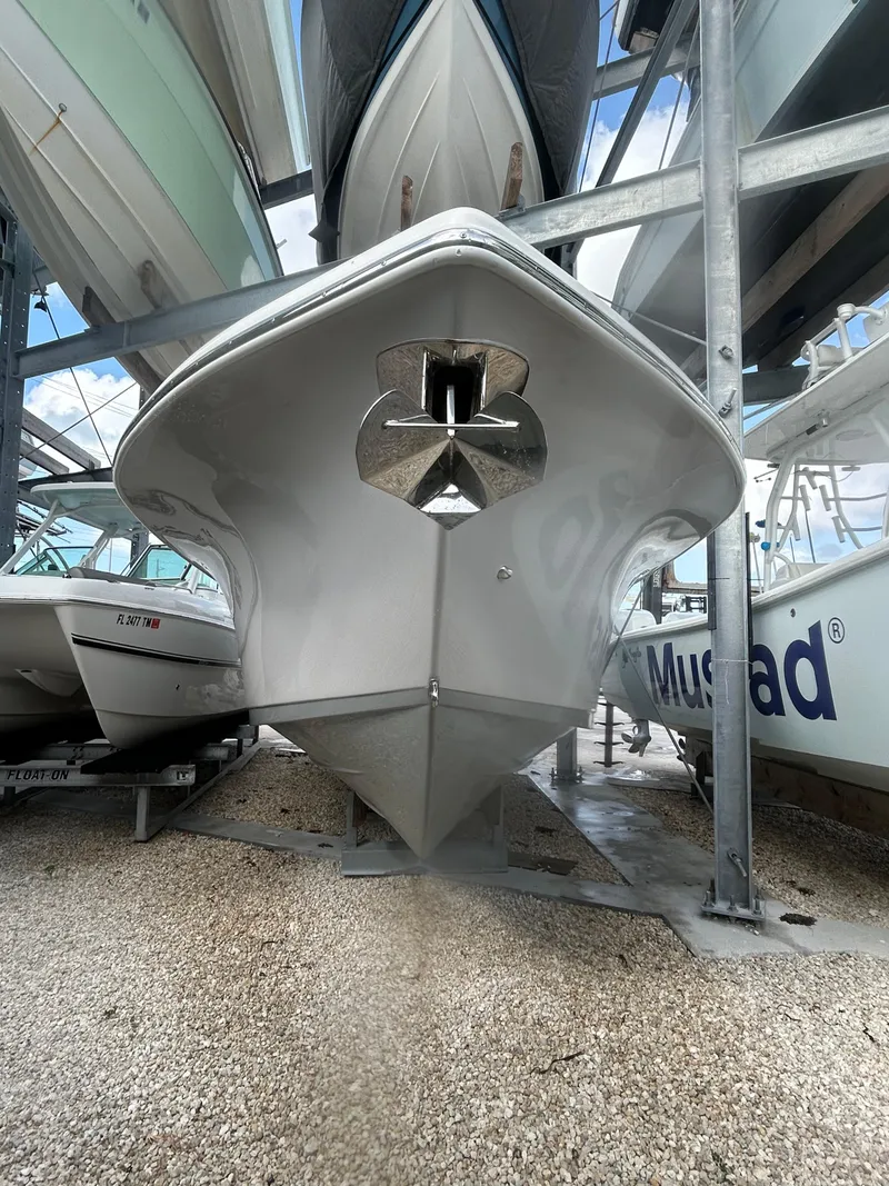 Slide: The Image of 2024 Sea Pro 320 DLX Center Console boat in storage, front view. - 5