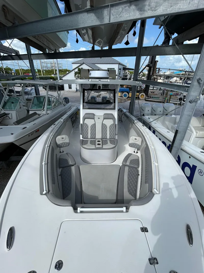 Slide: The Image of 2024 Sea Pro 320 DLX Center Console boat in storage, showcasing sleek design and seating. - 7