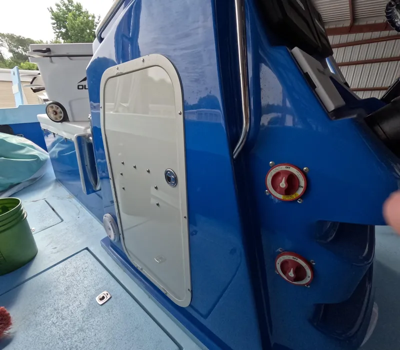 Slide: The Image of 2022 Eastward 30 boat on calm water, spacious deck, scenic shoreline view. - 12