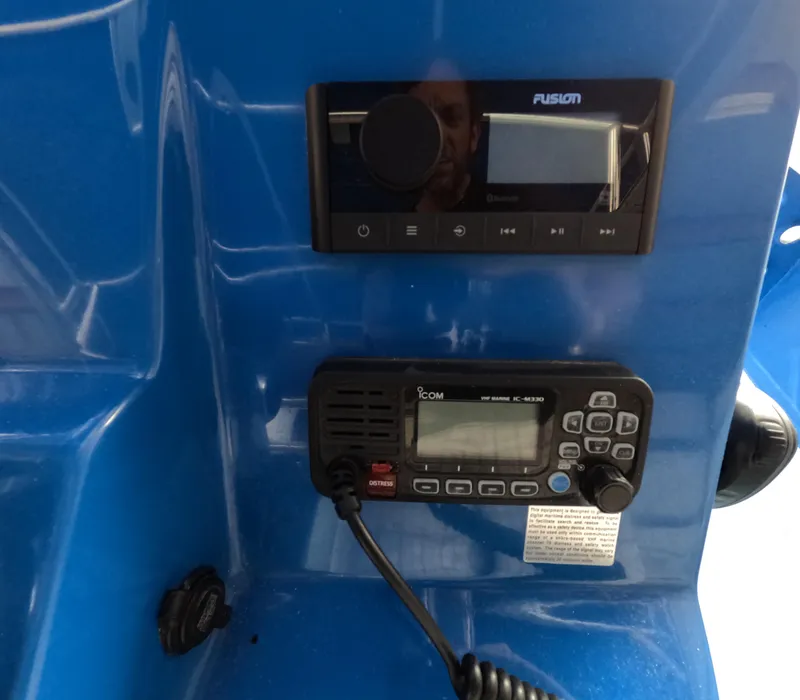 Slide: The Image of Interior view of 2022 Eastward 30 boat with blue seating and canopy. - 16