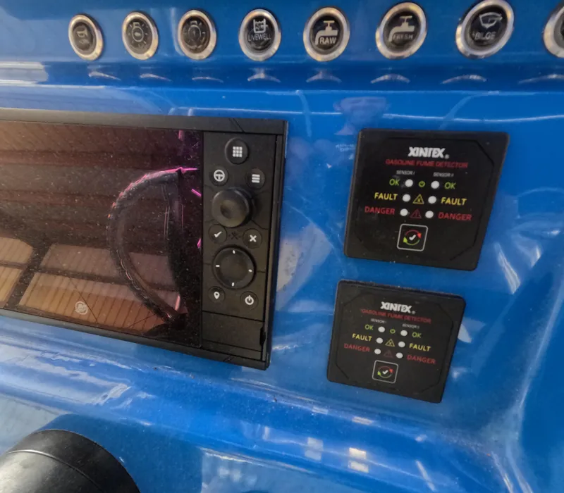 Slide: The Image of Control panel of 2022 Eastward 30 boat with navigation screens and steering wheel. - 17