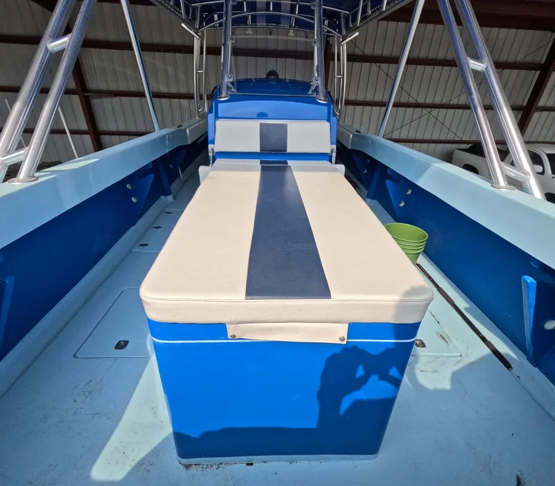 Slide: The Image of Open storage compartment on 2022 Eastward 30 boat deck by the water. - 25