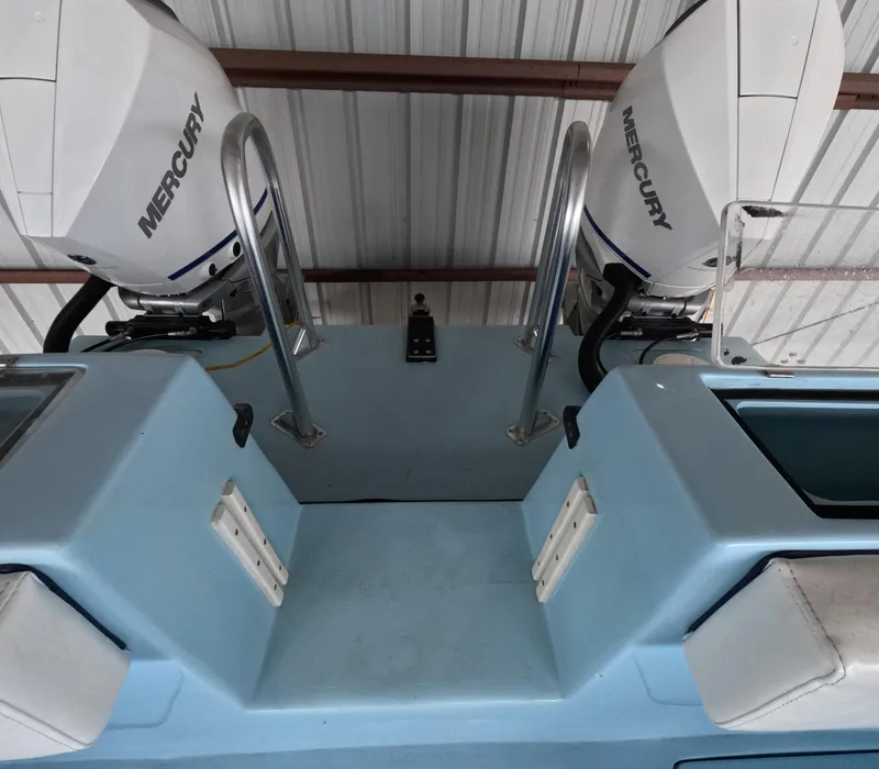 Slide: The Image of Open storage compartment on 2022 Eastward 30 boat, featuring blue interior and white hatch. - 27