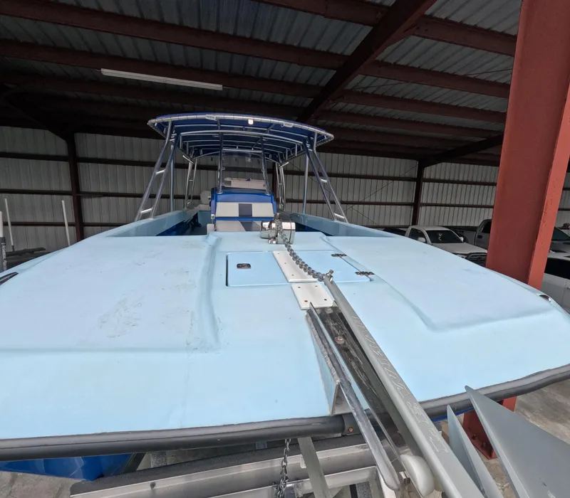 Slide: The Image of 2022 Eastward 30 boat with outboard motor and seating, on calm water. - 28