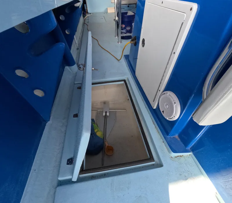 Slide: The Image of 2022 Eastward 30 boat with outboard motor and seating, on sparkling water. - 29