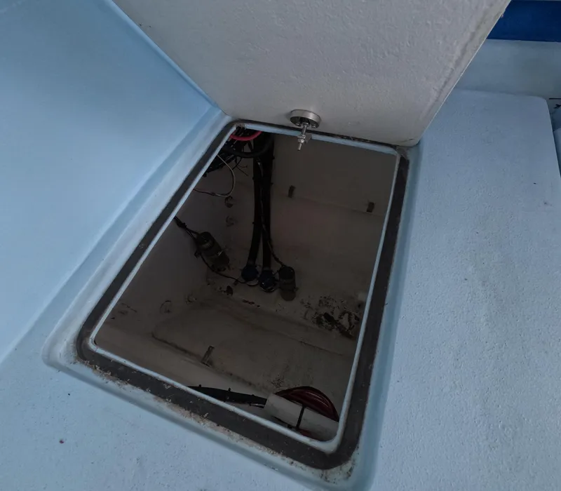 Slide: The Image of Open storage compartment on 2022 Eastward 30 boat deck, with ocean view. - 32