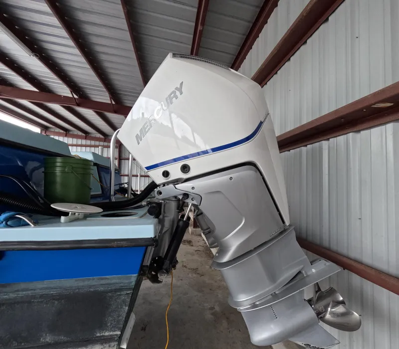 Slide: The Image of Blue 2022 Eastward 30 boat named "Cool Change" on calm water with trees in background. - 36