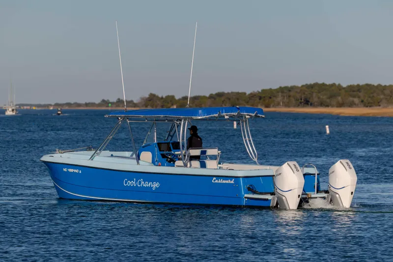 Slide: The Image of Blue 2022 Eastward 30 boat named "Cool Change" cruising on a calm lake. - 39