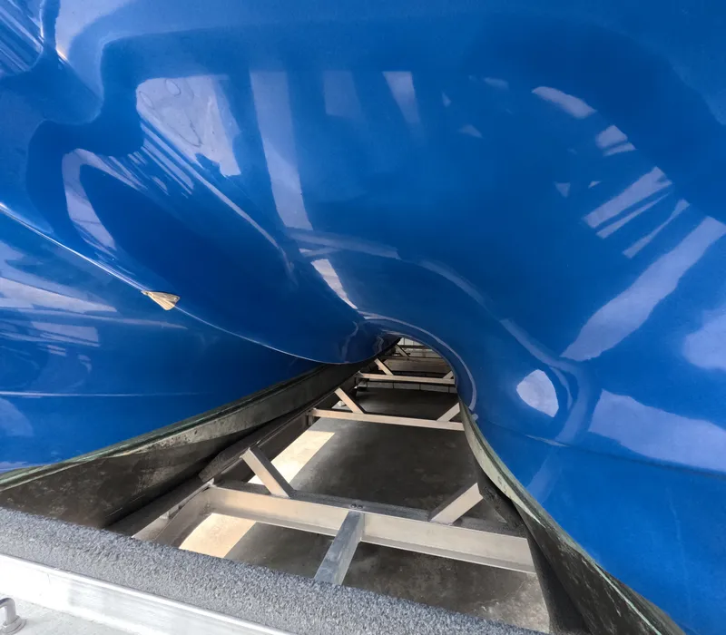 Slide: The Image of Twin Mercury outboard engines on a 2022 Eastward 30 boat, docked in a serene marina. - 6