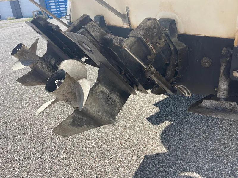 Slide: The Image of 1998 Cruisers 2870 Rogue boat propellers and outdrives on pavement. - 10