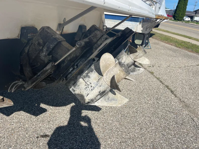 Slide: The Image of 1998 Cruisers 2870 Rogue boat propellers and outdrive on pavement. - 11