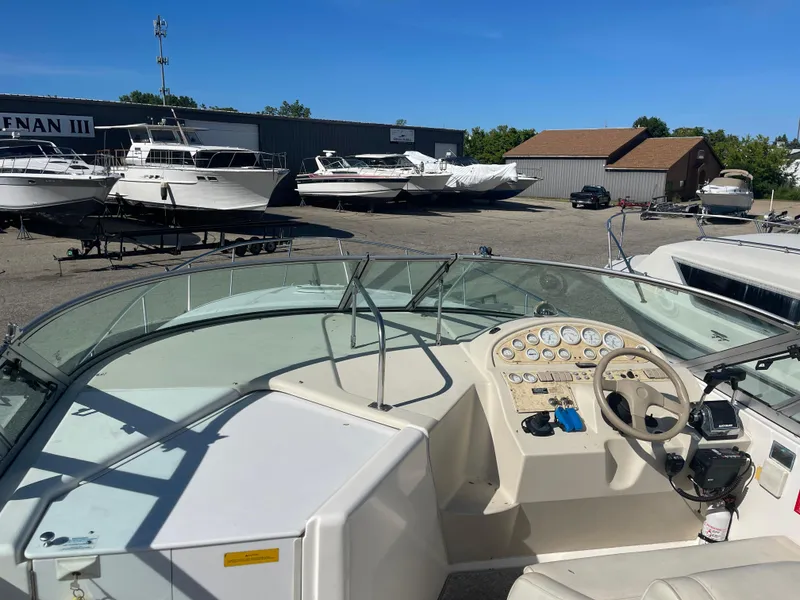 Slide: The Image of 1998 Cruisers 2870 Rogue boat dashboard with marina and boats in background. - 16