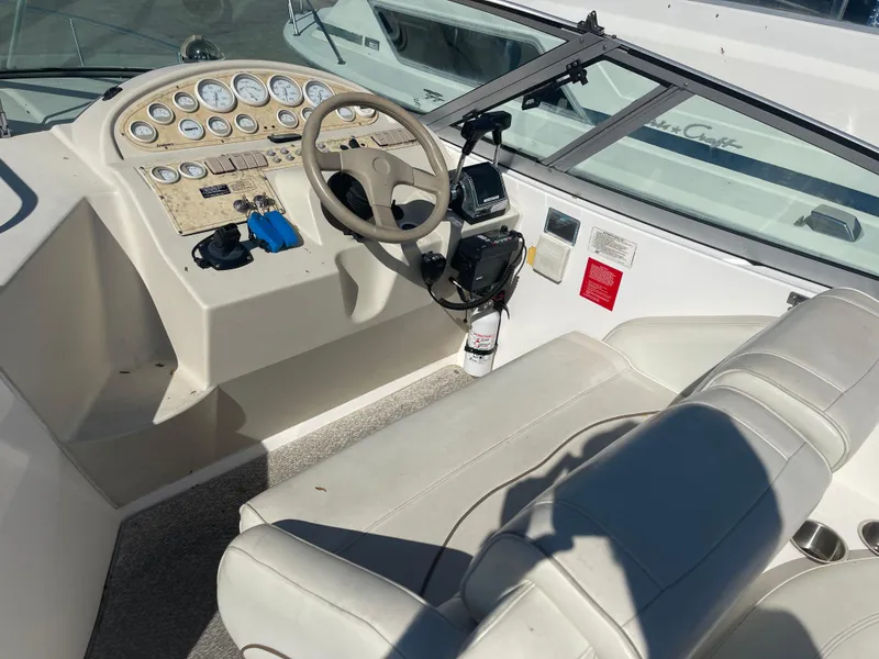 Slide: The Image of 1998 Cruisers 2870 Rogue boat cockpit with steering wheel and control panel. - 17