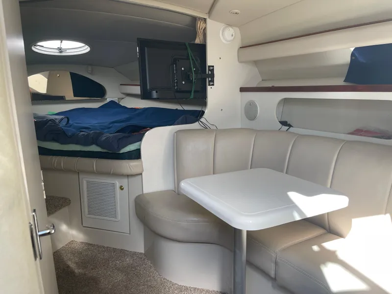Slide: The Image of Interior of 1998 Cruisers 2870 Rogue boat with seating and sleeping area. - 24