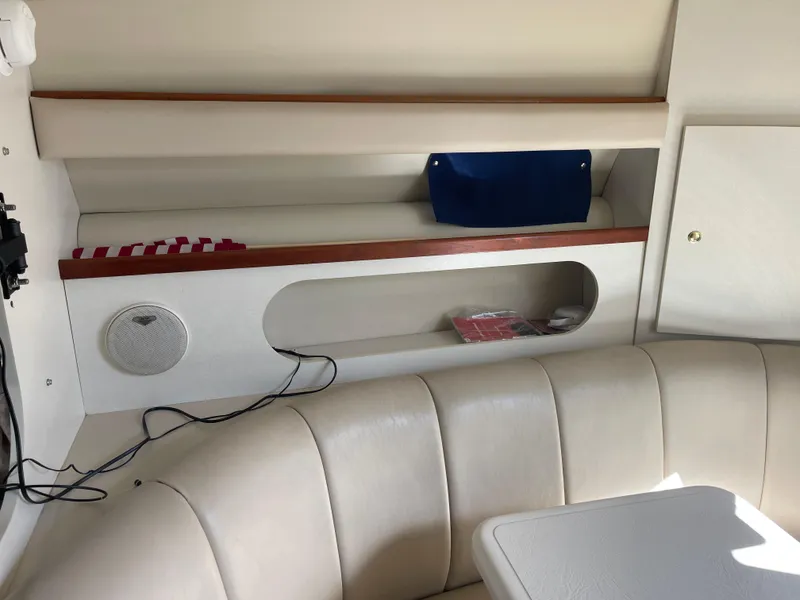 Slide: The Image of 1998 Cruisers 2870 Rogue cabin interior with beige seating, storage shelves, and speaker. - 29