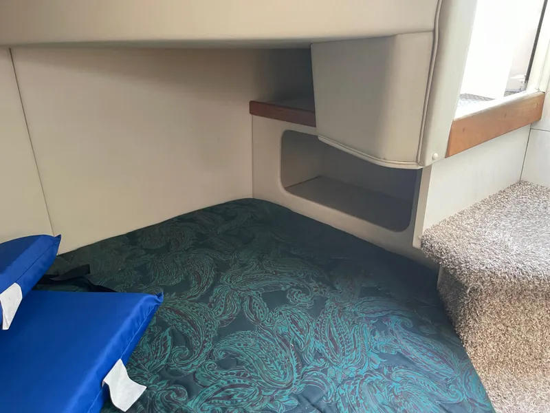 Slide: The Image of Interior cabin of 1998 Cruisers 2870 Rogue with patterned bedding and blue pillows. - 31
