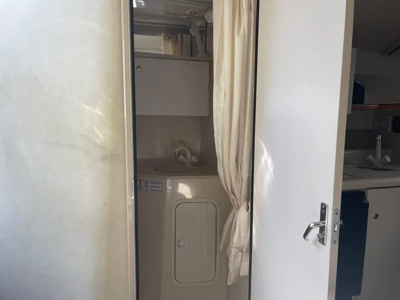 Slide: The Image of 1998 Cruisers 2870 Rogue boat interior with bathroom and sink area. - 32