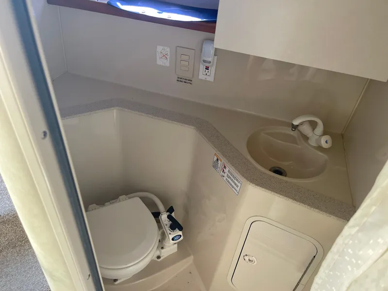 Slide: The Image of 1998 Cruisers 2870 Rogue boat bathroom with toilet and sink. - 33