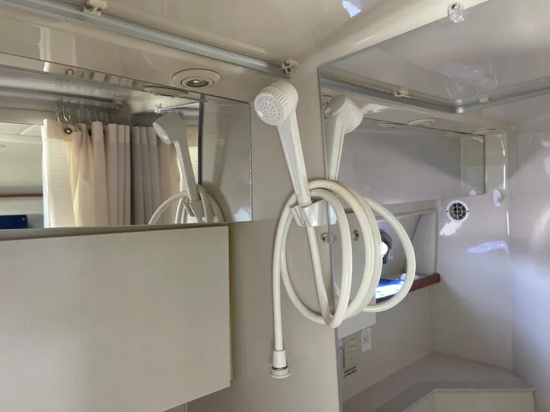 Slide: The Image of 1998 Cruisers 2870 Rogue boat interior with showerhead and mirror. - 34
