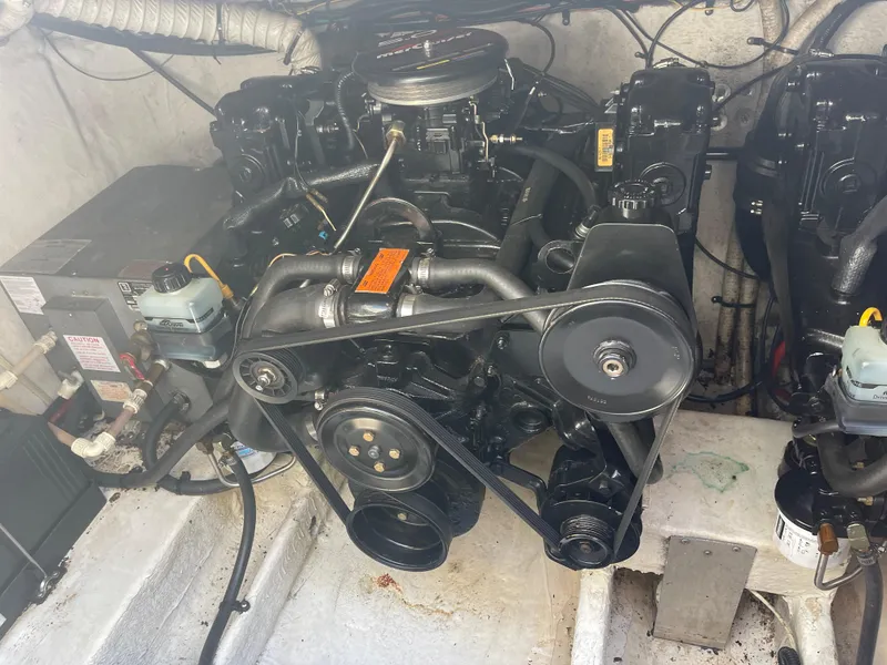 Slide: The Image of Engine compartment of a 1998 Cruisers 2870 Rogue boat, showcasing mechanical components. - 39