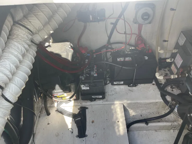 Slide: The Image of Engine compartment of a 1998 Cruisers 2870 Rogue boat, showing batteries and wiring. - 41