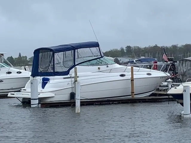 Slide: The Image of 1998 Cruisers 2870 Rogue boat docked in a marina on a cloudy day. - 43
