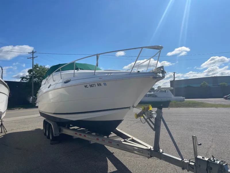 Slide: The Image of 1998 Cruisers 2870 Rogue boat on trailer under clear blue sky. - 5