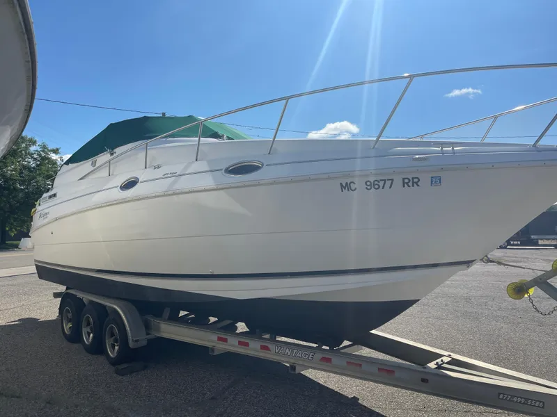 Slide: The Image of 1998 Cruisers 2870 Rogue boat on trailer under clear blue sky. - 6
