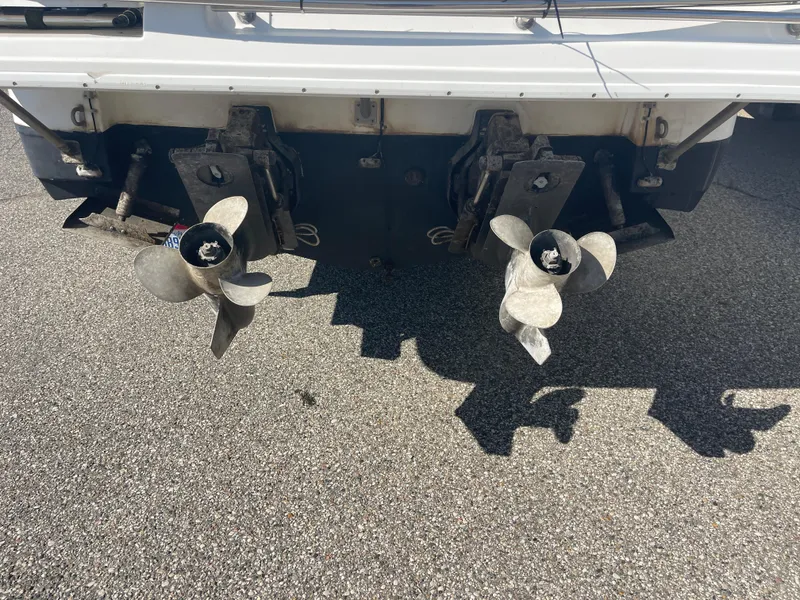 Slide: The Image of 1998 Cruisers 2870 Rogue boat propellers on asphalt surface. - 9