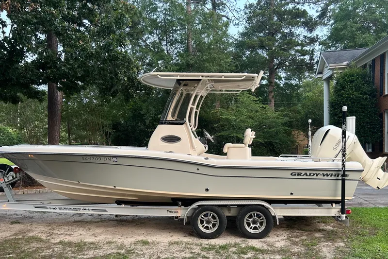 Slide: The Image of 2021 Grady-White 251 Coastal Explorer boat on trailer, parked outdoors. - 1