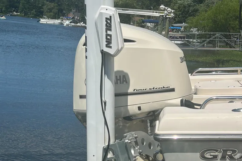 Slide: The Image of 2021 Grady-White 251 Coastal Explorer with Yamaha four-stroke engine on a serene lake. - 10