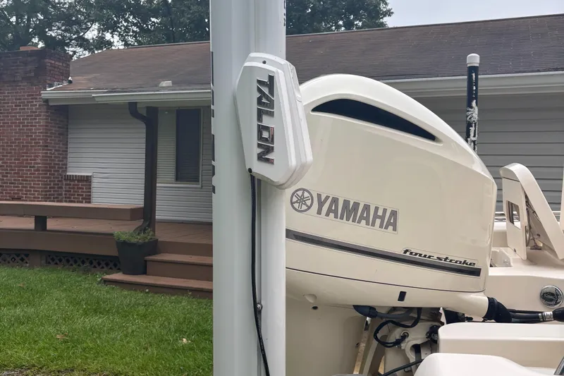 Slide: The Image of 2021 Grady-White 251 Coastal Explorer with Yamaha four-stroke engine, parked near a house. - 15