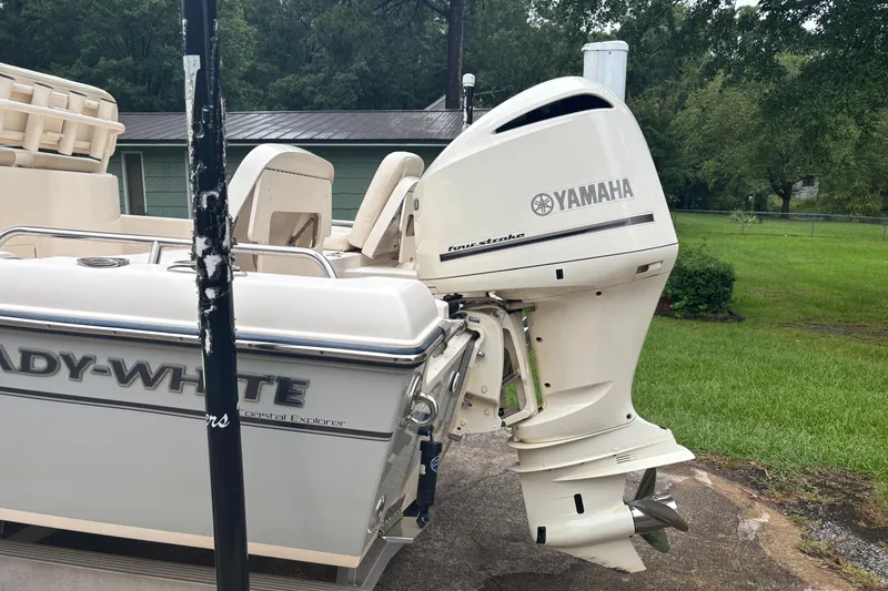 Slide: The Image of 2021 Grady-White 251 Coastal Explorer boat with Yamaha outboard motor in a yard setting. - 17